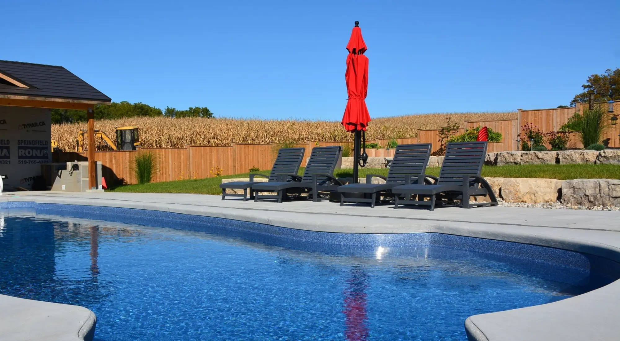 Inground vinyl pool with lounge chairs