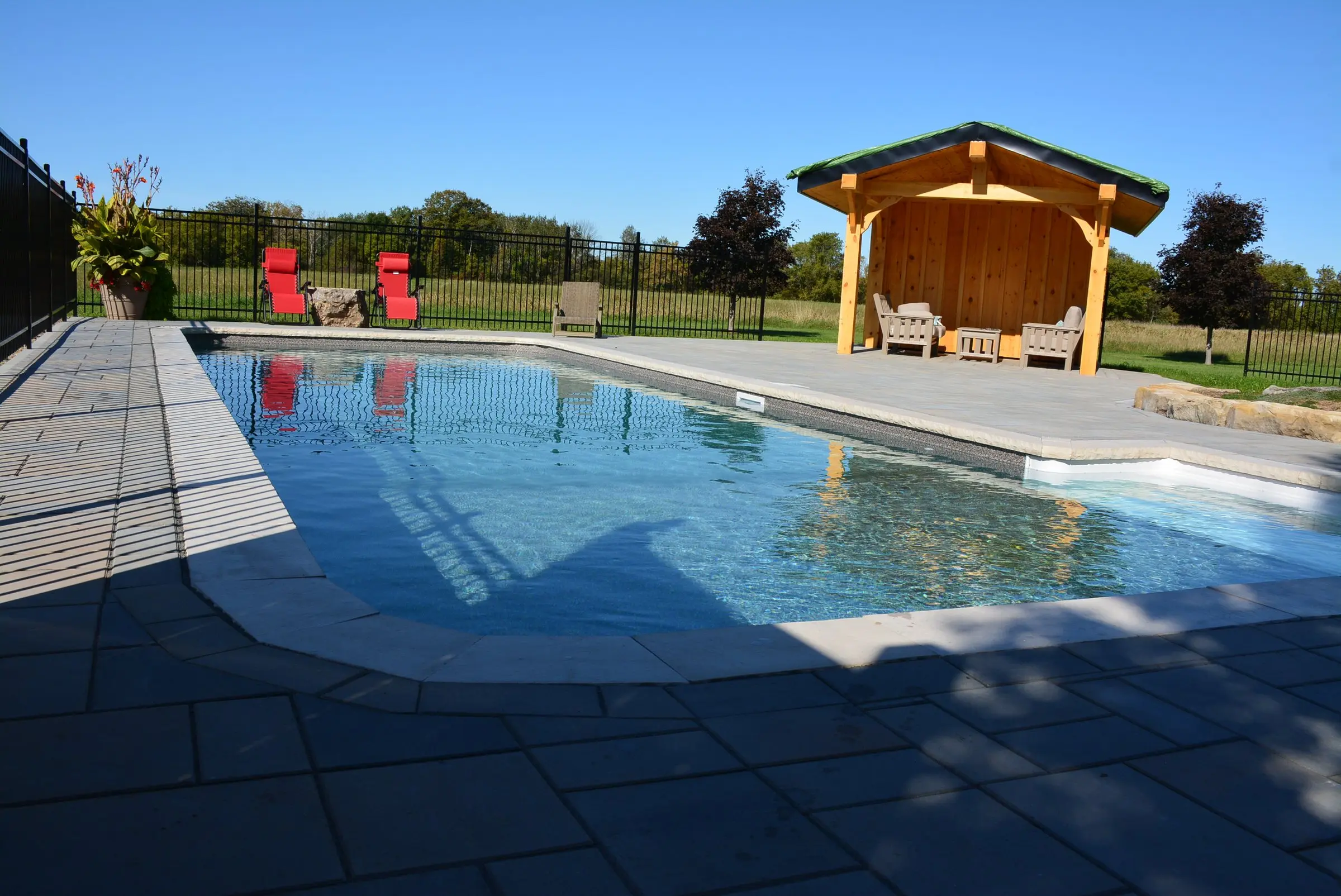 Inground pool with cabana and paver patio