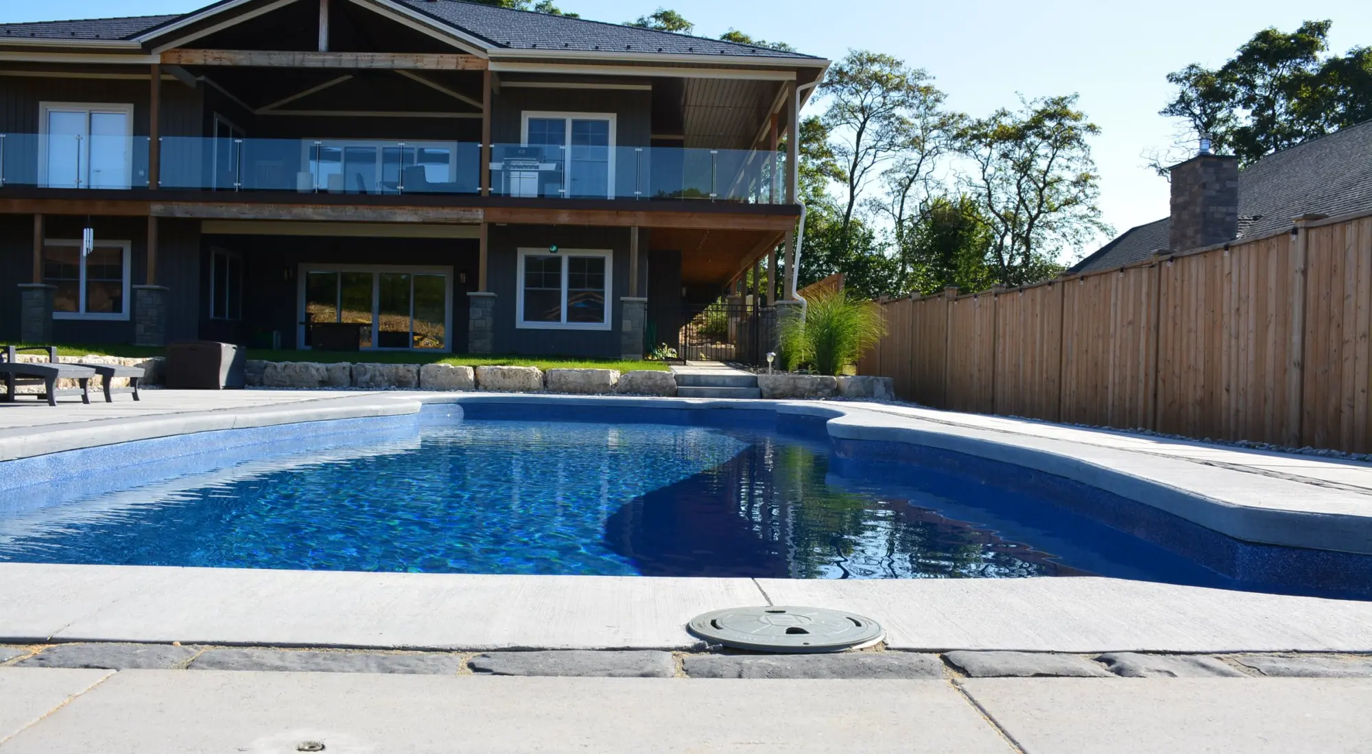 Inground pool behind a two storey home