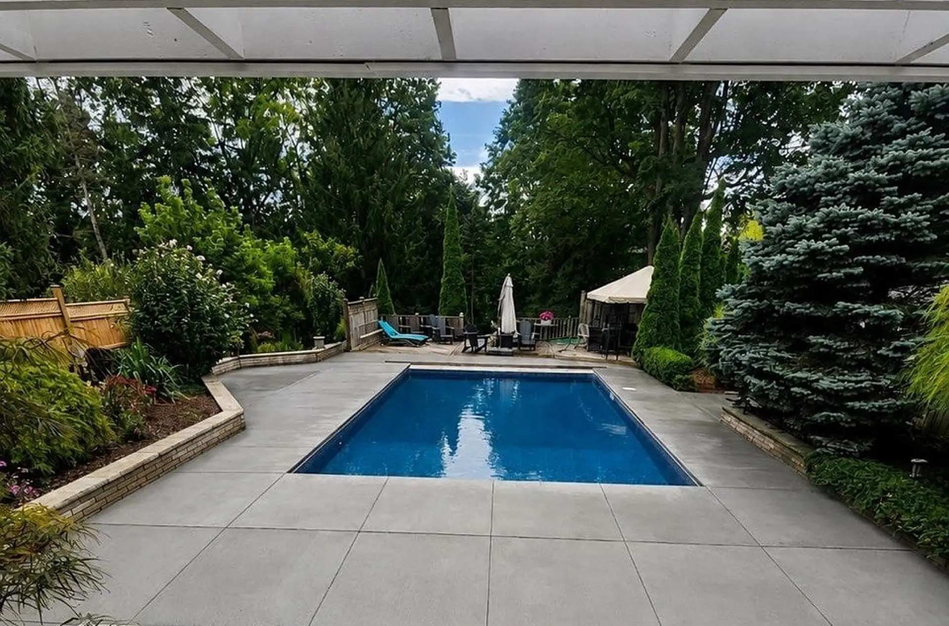 Renovated backyard pool with new concrete deck