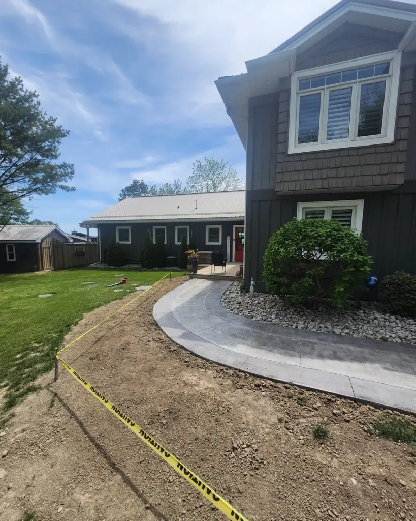 Finished walkway curving up to the house